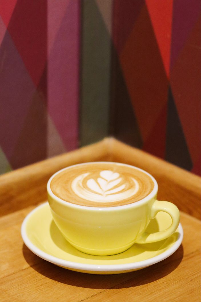 Yellow coffee cup with cappuccino